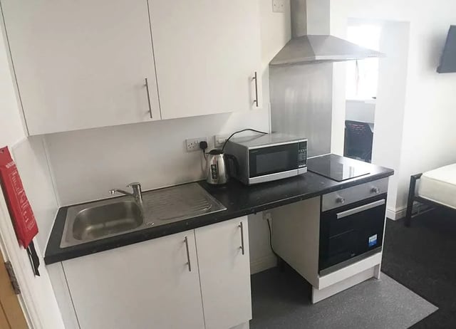 Kitchenette with sink microwave kettle and oven kitchen at Forest Rise in Loughborough Student Accommodation