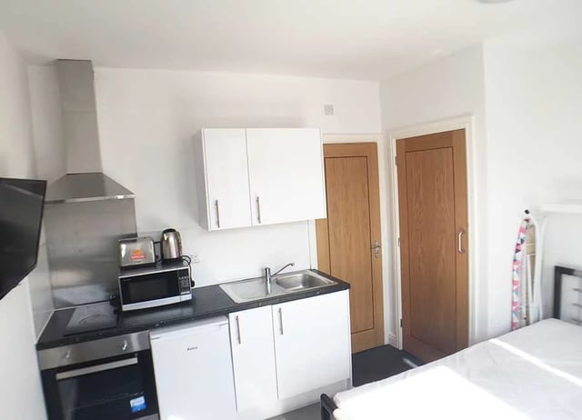 Kitchenette with microwave sink oven bed living room at Forest Rise in Loughborough Student Accommodation