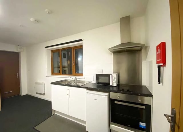 Sink microwave oven white cabinets kitchen at Forest Rise in Loughborough Student Accommodation