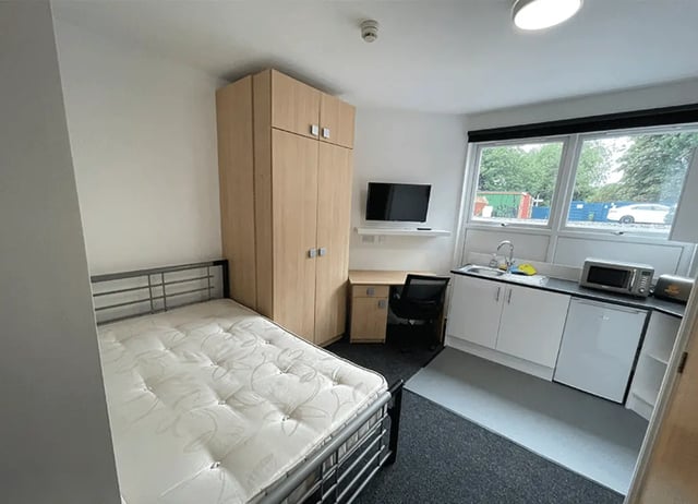 Bed wardrobe desk kitchen area and TV studio flat at Forest Rise in Loughborough Student Accommodation