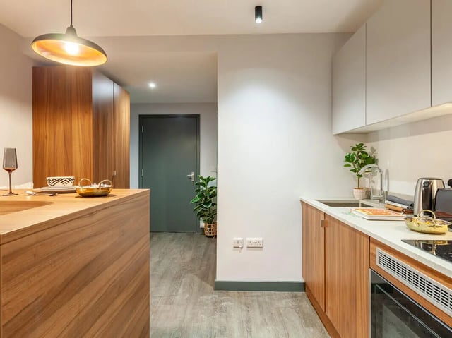 Wooden cabinets sink and appliances kitchen at Straits Garden in Egham Student Accommodation