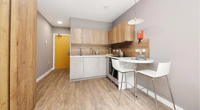 Kitchen with table two chairs and cabinets kitchen at 800 Bristol Road in Birmingham Student Accommodation