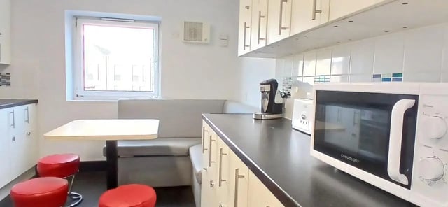 Counter microwave seating and table kitchen at Hamwic Hall in Southampton Student Accommodation