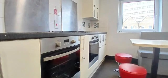 Modern kitchen with oven, stools and table kitchen at Hamwic Hall in Southampton Student Accommodation