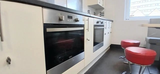 Two ovens two red stools kitchen at Hamwic Hall in Southampton Student Accommodation