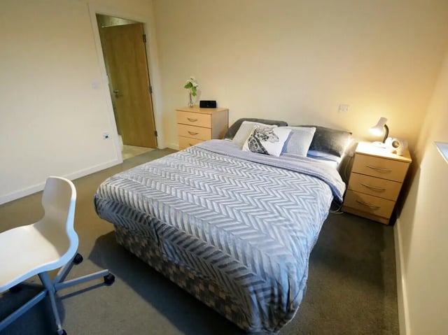 Bed desk chair and nightstand bedroom interior at Hassells Bridge House in Newcastle Under Lyme Student Accommodation