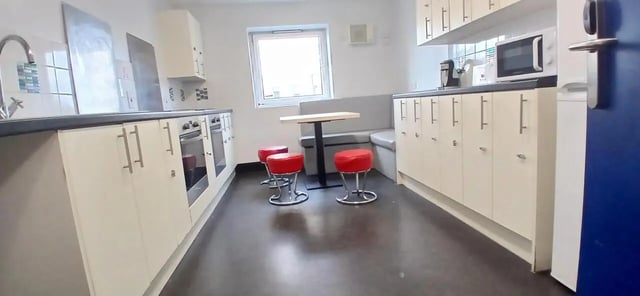 Kitchen with sink oven stools and table kitchen at Hamwic Hall in Southampton Student Accommodation