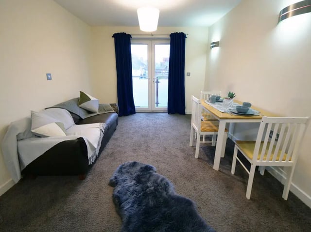 Sofa dining table chairs near patio doors Living room at Hassells Bridge House in Newcastle Under Lyme Student Accommodation