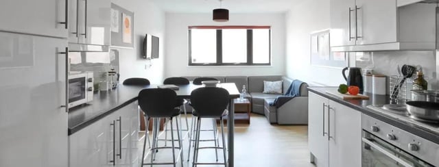 Modern kitchen with dining area and sofa Living room at The Printworks in Exeter Student Accommodation