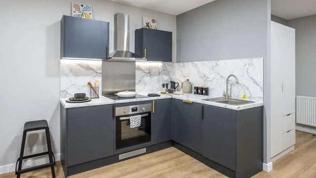 Modern grey student kitchen with oven and marble backsplash kitchen at Clyde Court in Glasgow Student Accommodation