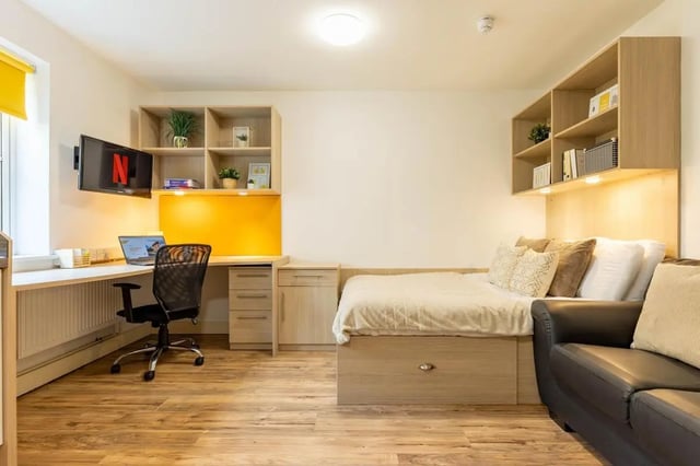 Bed desk TV bookshelves couch bedroom study area at Iron Bridge Studios in Exeter Student Accommodation
