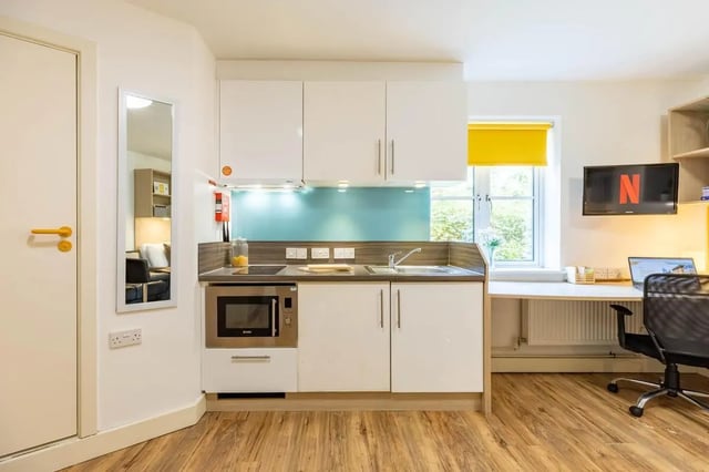 Kitchenette with microwave sink and desk area kitchen at Iron Bridge Studios in Exeter Student Accommodation