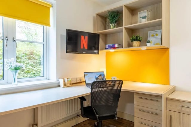 Desk with laptop chair shelves TV study area at Iron Bridge Studios in Exeter Student Accommodation