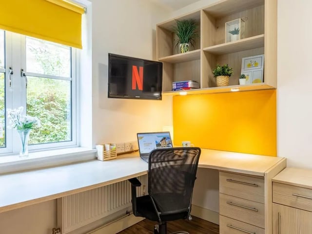 Desk with laptop chair and shelves Study area at Iron Bridge Studios in Exeter Student Accommodation