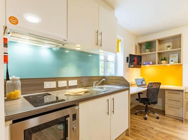 Kitchenette with desk and chair kitchen area at Iron Bridge Studios in Exeter Student Accommodation