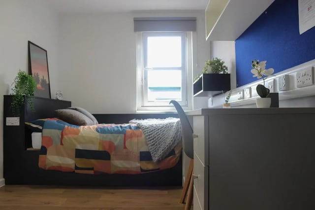 Bed with colorful bedding and grey desk Bedroom at The Bridge Guildford in Guildford Student Accommodation