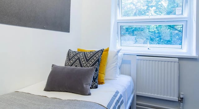 Bed with pillows window and radiator bedroom at Green Wood Court in Southampton Student Accommodation