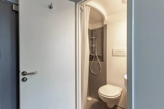 Toilet shower curtain and sink bathroom at The Bridge Guildford in Guildford Student Accommodation