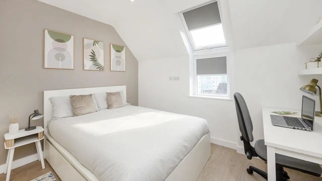 Bed with desk and artwork bedroom at Sizer Court in Preston Student Accommodation
