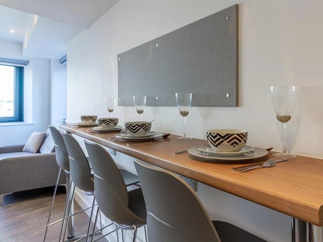 Bar with chairs and table setting dining area at Saltwater Place in Plymouth Student Accommodation