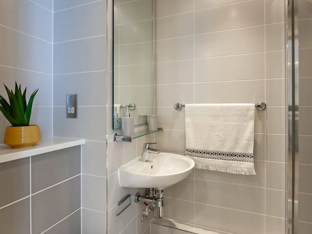 Sink mirror plant towel bathroom at Saltwater Place in Plymouth Student Accommodation