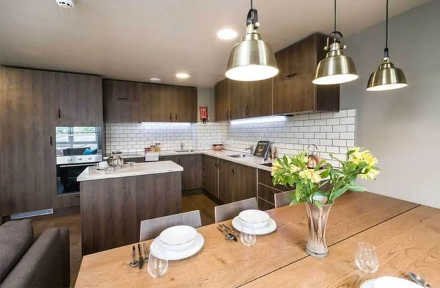 Modern kitchen with island and dining table kitchen at Ernest Place in Durham Student Accommodation