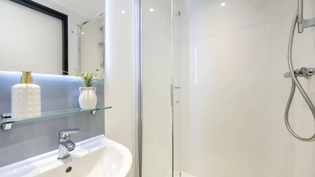 Sink soap dispenser plant shower enclosure bathroom at Innovo House in Liverpool Student Accommodation