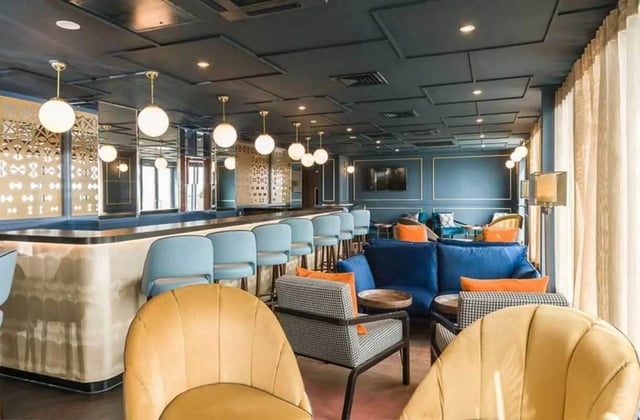 Bar with blue stools and lounge seating living room at Ernest Place in Durham Student Accommodation