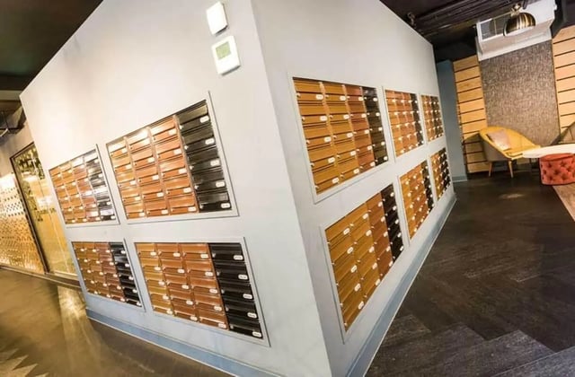 Mailboxes on wall with seating area exterior at Ernest Place in Durham Student Accommodation