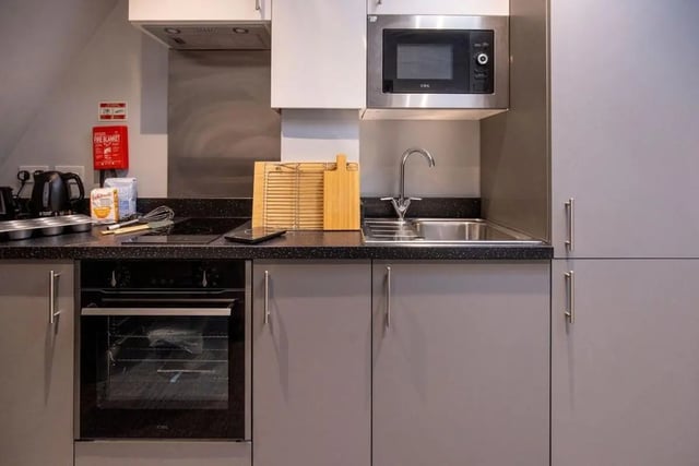 Oven microwave hob sink chopping board kitchen at Ash Grove Court - Guildford in Guildford Student Accommodation