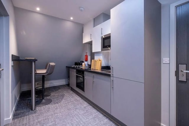 Modern grey kitchen with bar stools and microwave kitchen at Ash Grove Court - Guildford in Guildford Student Accommodation