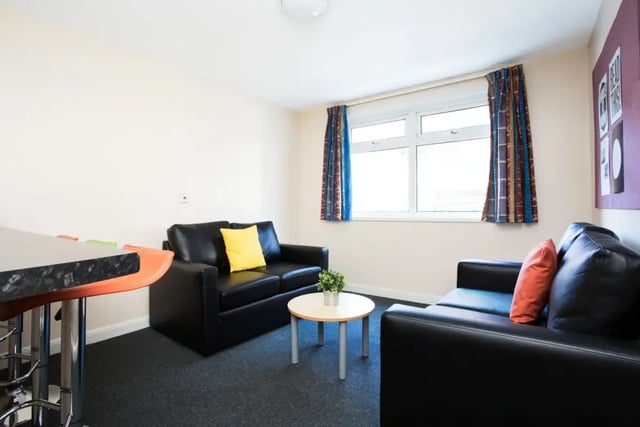 Two black sofas and a table living room at St Martins House in Leicester Student Accommodation