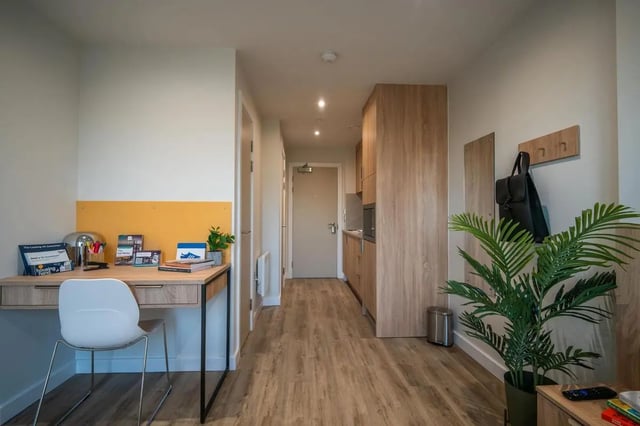 Desk chair kitchen cabinets with plants bedroom at The Sail Works in Lancaster Student Accommodation
