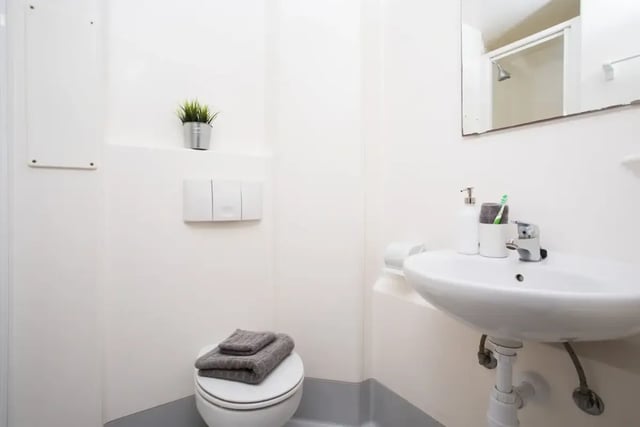 Toilet sink soap toothbrush towels plant bathroom at St Martins House in Leicester Student Accommodation