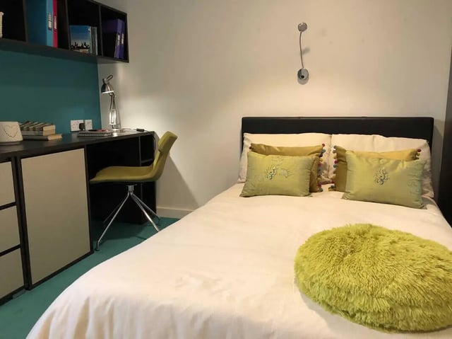 Desk chair bed with pillows and fluffy cushion bedroom at Plato House in Liverpool Student Accommodation