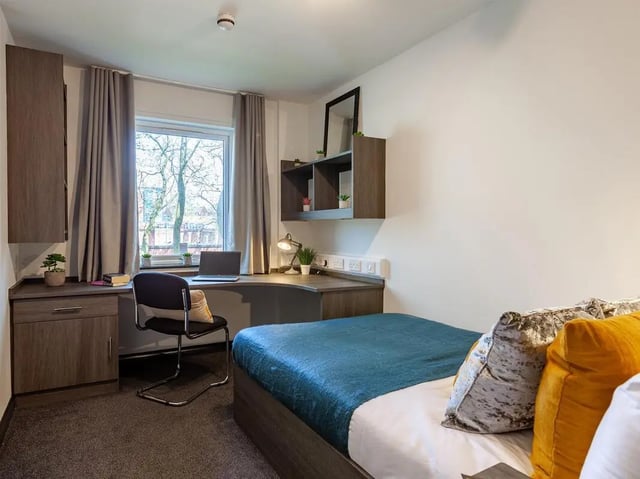Bed desk chair laptop shelves window bedroom at Trinity Student Village in Preston Student Accommodation