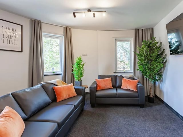 Two black sofas with orange cushions living room at Trinity Student Village in Preston Student Accommodation