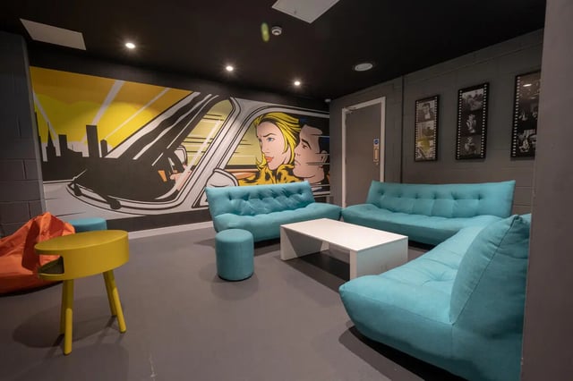 Turquoise sofas coffee table beanbags pop art living room at Plato House in Liverpool Student Accommodation