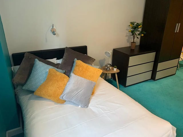 Bed with pillows bedside table drawers wardrobe bedroom at Plato House in Liverpool Student Accommodation