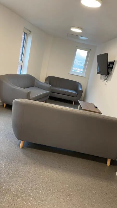 Three grey sofas and coffee table living room at Phoenix Place in Liverpool Student Accommodation