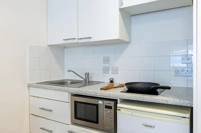 Sink microwave fridge frying pan kitchen at St Augustine's House in Plymouth Student Accommodation