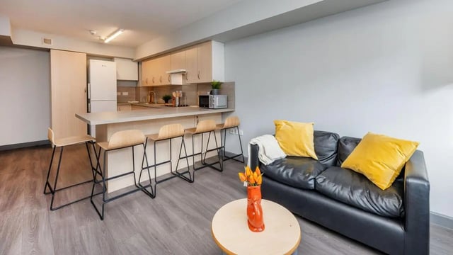Sofa kitchen counter bar stools living area at The Forge in Sheffield Student Accommodation