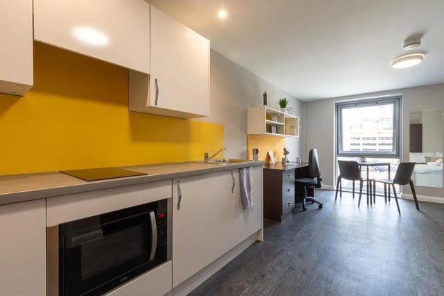 Microwave sink desk chairs table kitchen living room at One Islington Plaza in Liverpool Student Accommodation