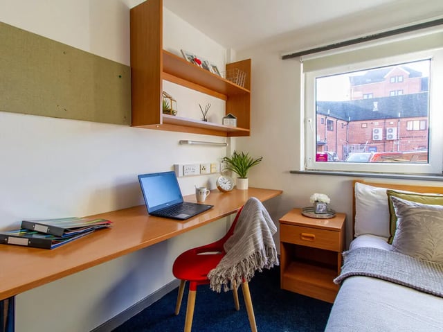 Desk with laptop plant and chair student room at The Print House in Loughborough Student Accommodation