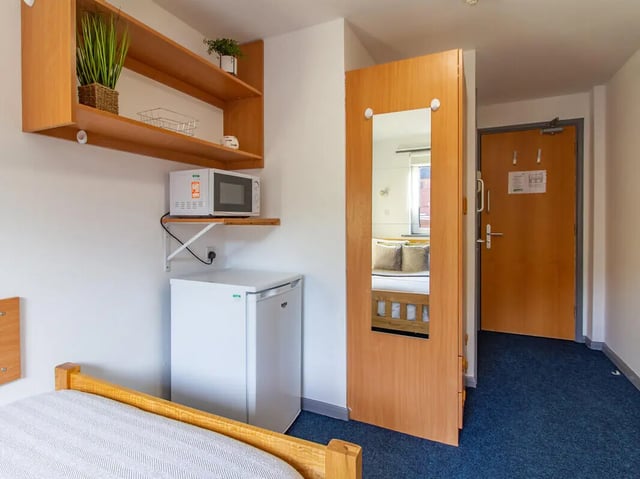 Microwave fridge shelves and bed bedroom at The Print House in Loughborough Student Accommodation