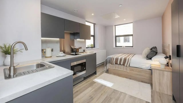 Bed kitchen area with microwave and sink. at Headrow Court in Leeds Student Accommodation
