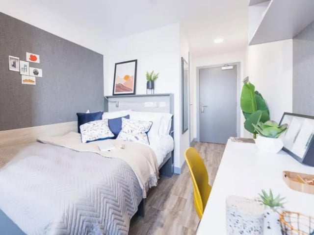 Bed with pillows artwork and desk bedroom at Onyx Birmingham in Birmingham Student Accommodation