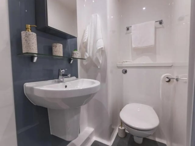 Sink toilet soap dispenser towel bathroom at Onyx Birmingham in Birmingham Student Accommodation