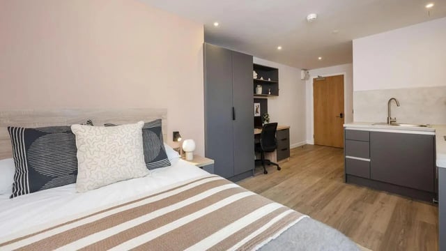 Bed desk closet and kitchen studio apartment at Headrow Court in Leeds Student Accommodation