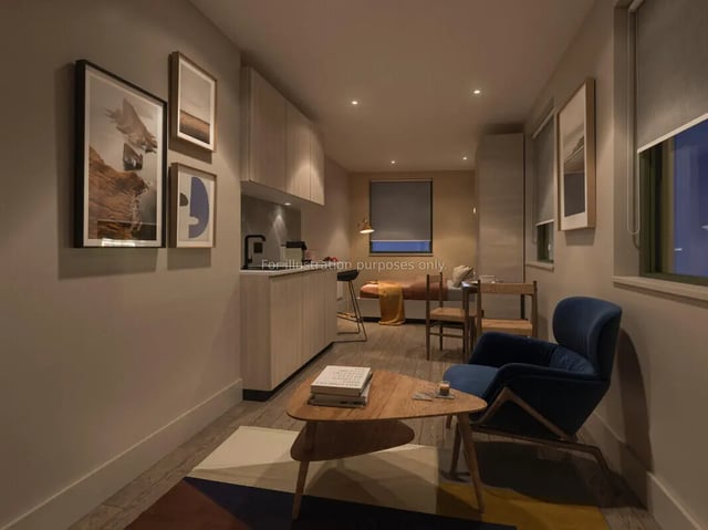 Living area with blue armchair and wooden coffee table Living area at Tribu Kingston in Kingston Upon Thames Student Accommodation